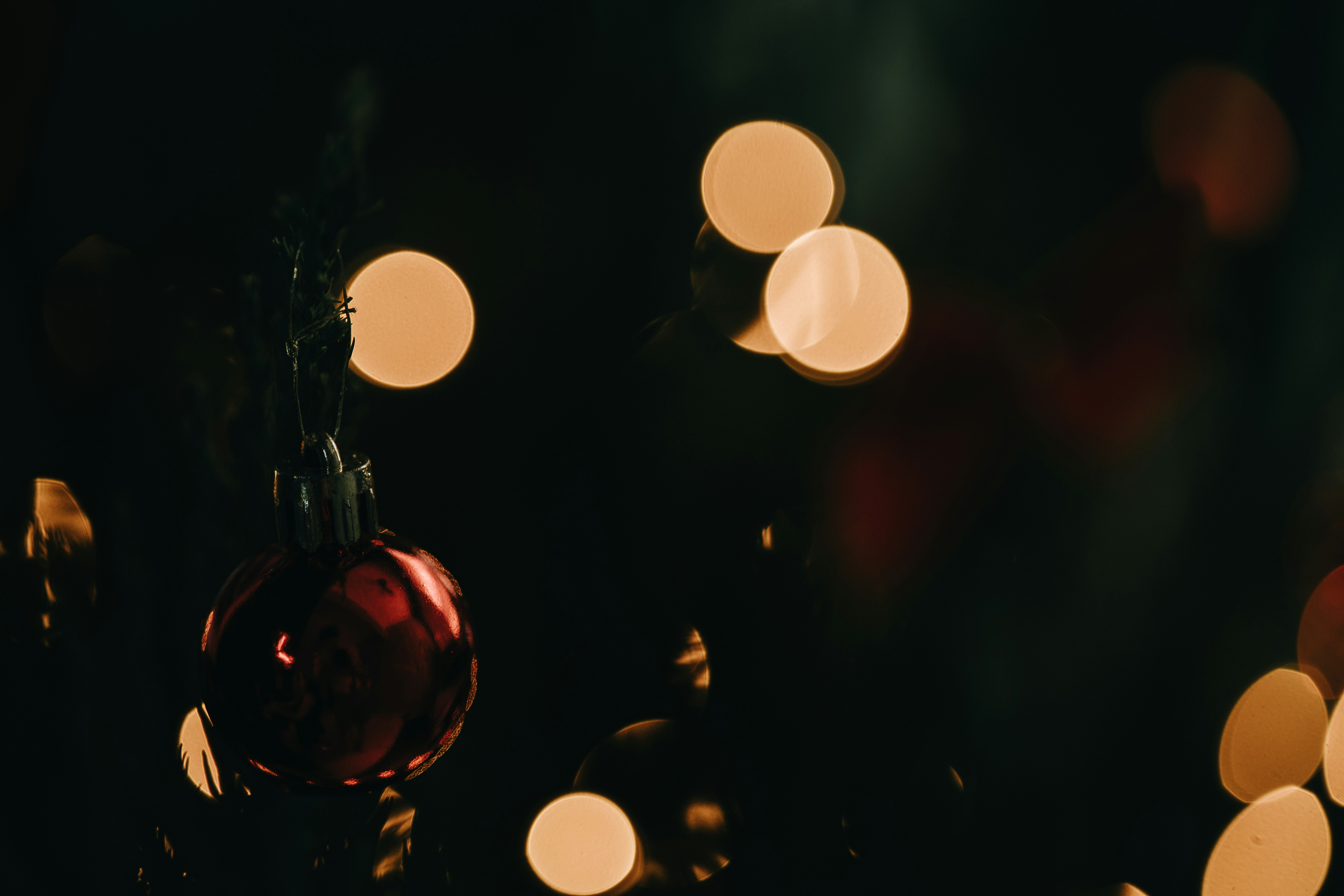 a red ornament hanging from a string of lights