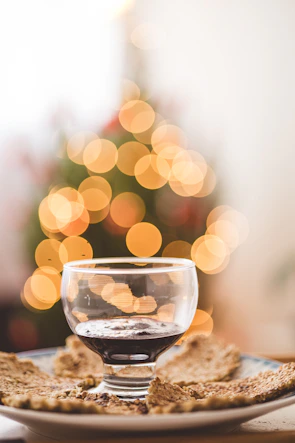 Close-up of a glass of red wine beside a plate of traditional Tuscan antipasti.