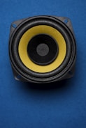a close up of a speaker on a blue surface
