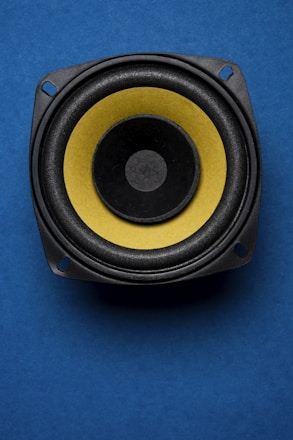 a close up of a speaker on a blue surface