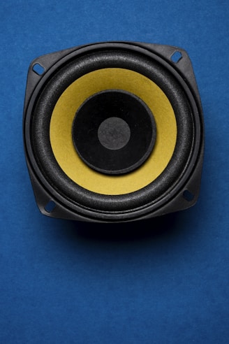 a close up of a speaker on a blue surface