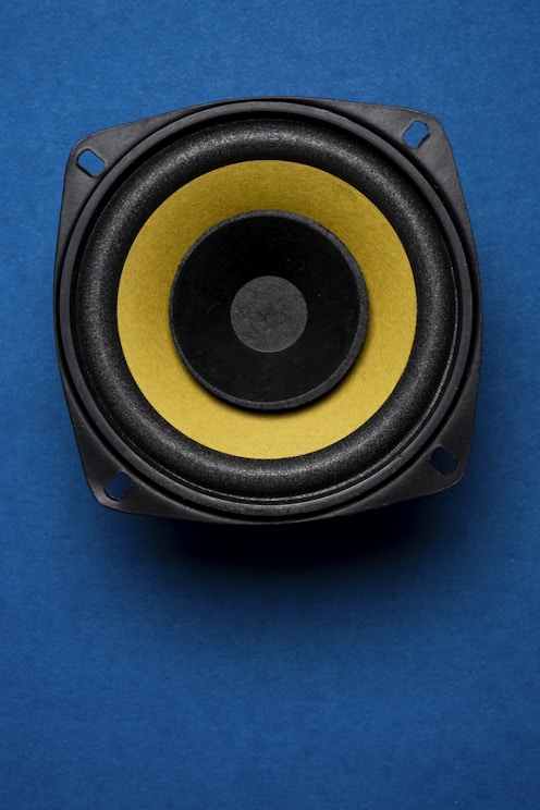 a close up of a speaker on a blue surface