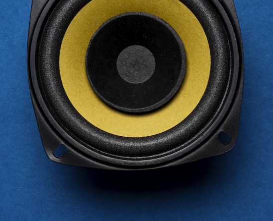 a close up of a speaker on a blue surface