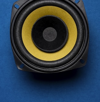 a close up of a speaker on a blue surface