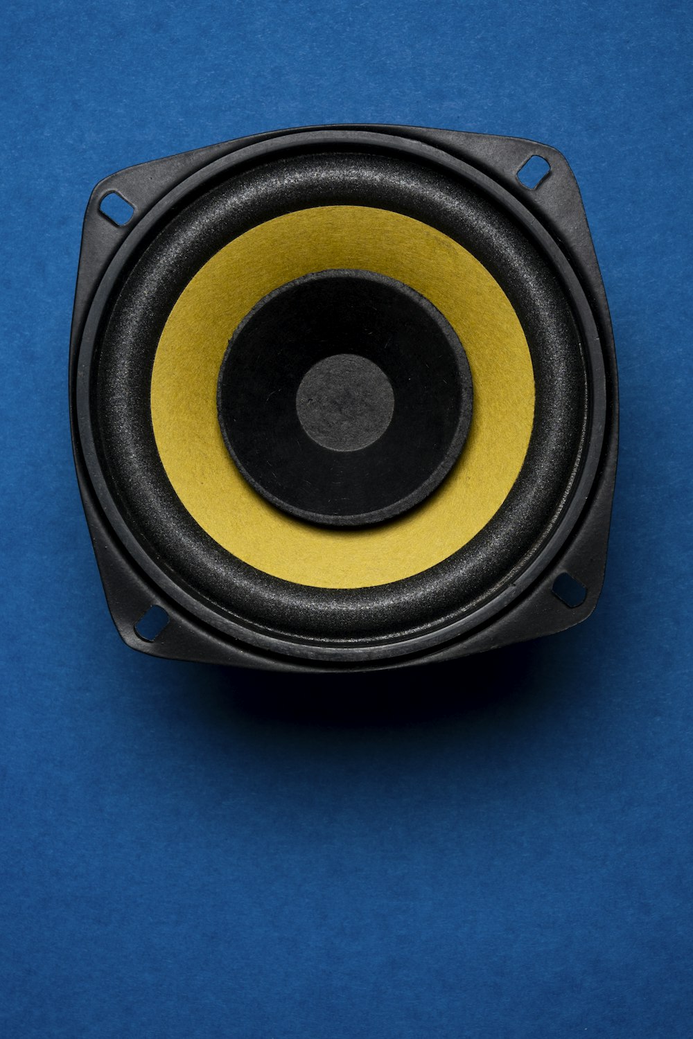 a close up of a speaker on a blue surface