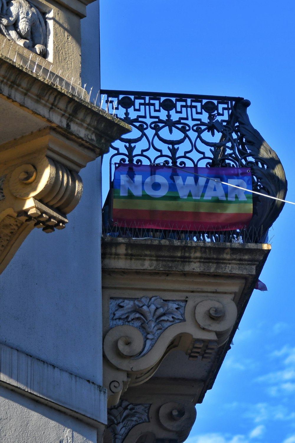 a rainbow flag hanging off the side of a building