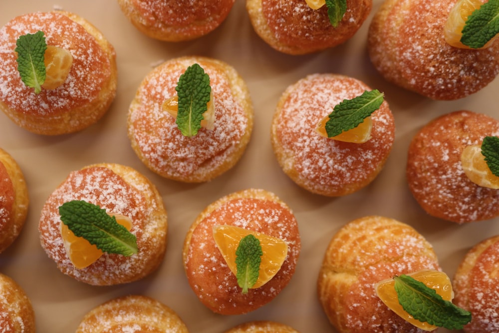 a close up of a plate of doughnuts covered in powdered sugar