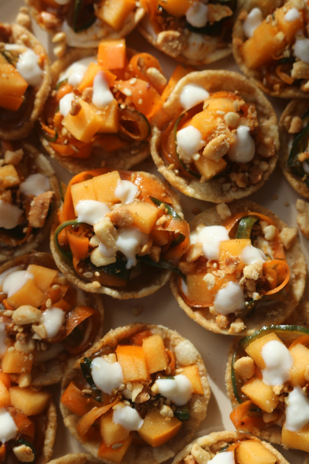 a white plate topped with mini pizzas covered in toppings