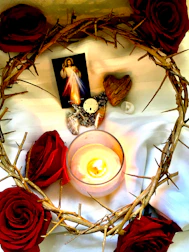 Close-up of a handwritten prayer card next to a candle glowing softly.