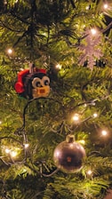 A festive display of custom LEGO Christmas ornaments hanging on a decorated tree.