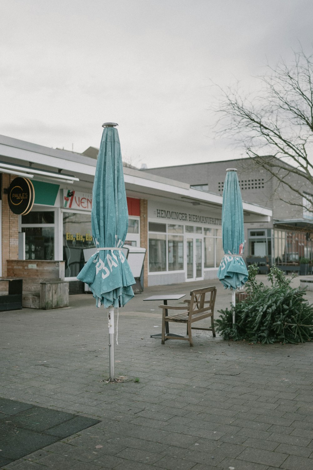 a couple of umbrellas sitting on top of a sidewalk