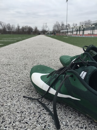 A pair of athletic shoes on a running track.