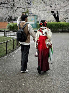Happy couple exploring the vibrant streets of Tokyo with cherry blossoms in bloom