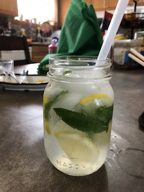 A refreshing, homemade detox water jar filled with citrus and mint.