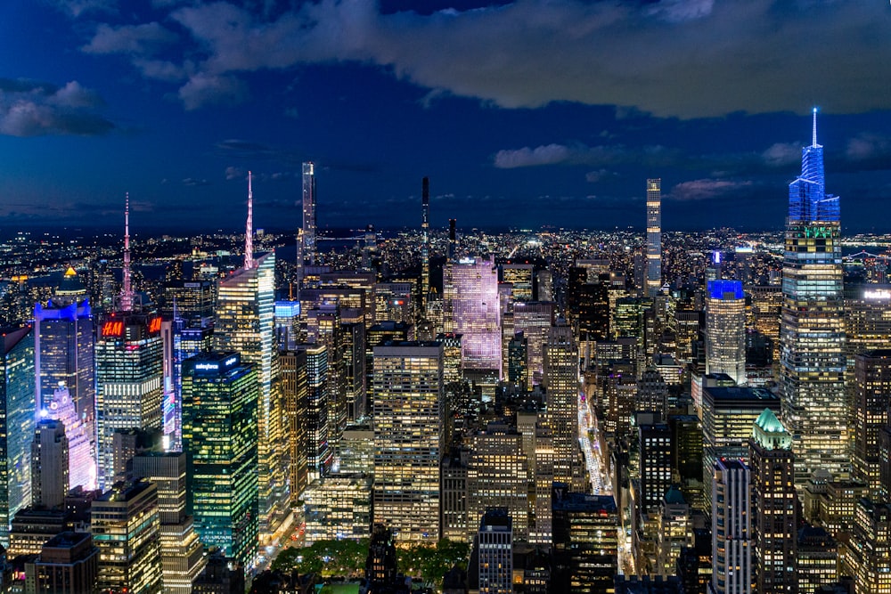 a view of a city at night from the top of a skyscraper