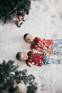 Children playing in a snowy environment, surrounded by Christmas decorations.