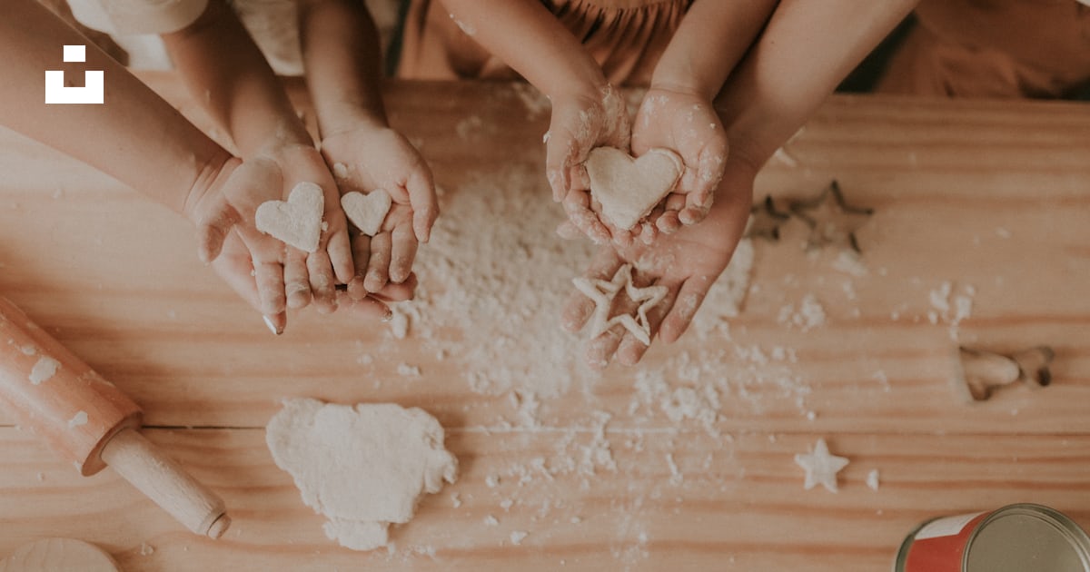 A group of people making heart shaped cookies photo – Free Human Image ...