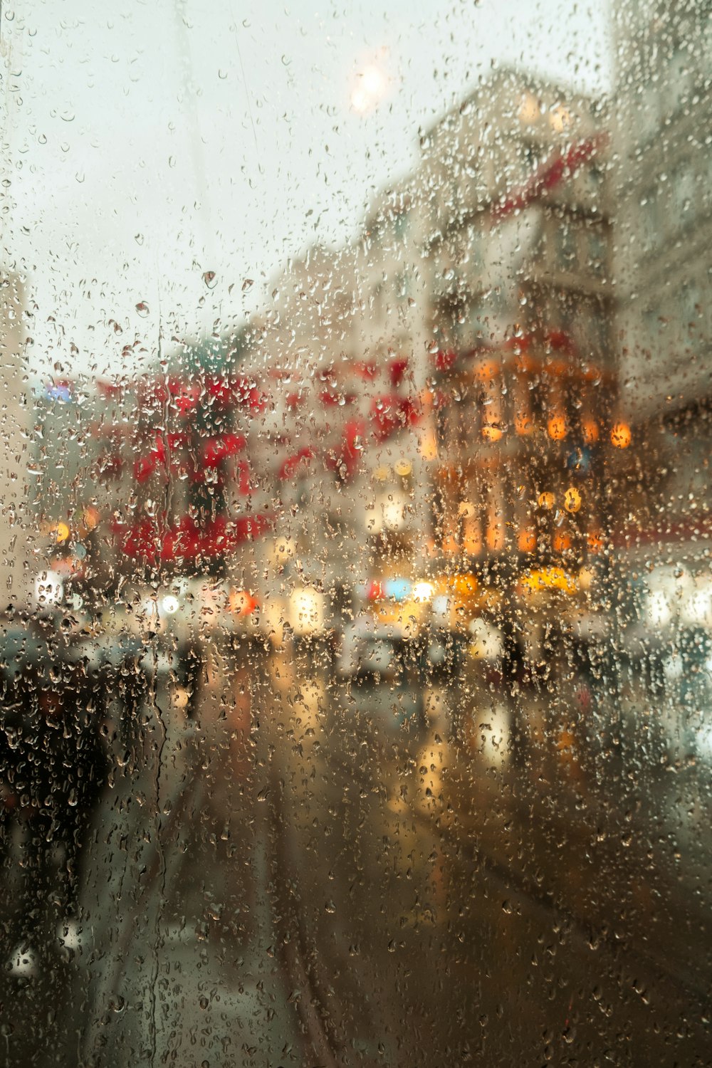 a view of a city street through a rain covered window