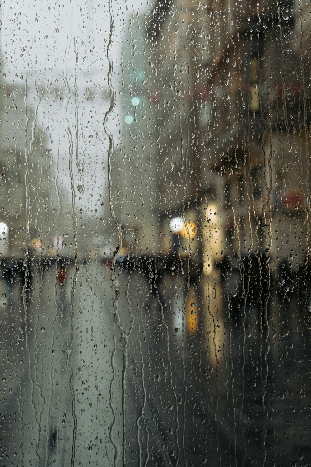 a view of a city street through a rain covered window