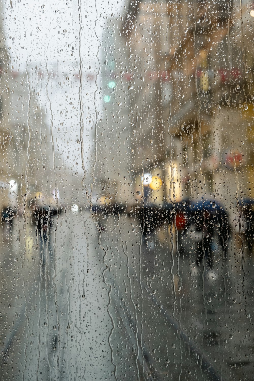 a view of a city street through a rain covered window