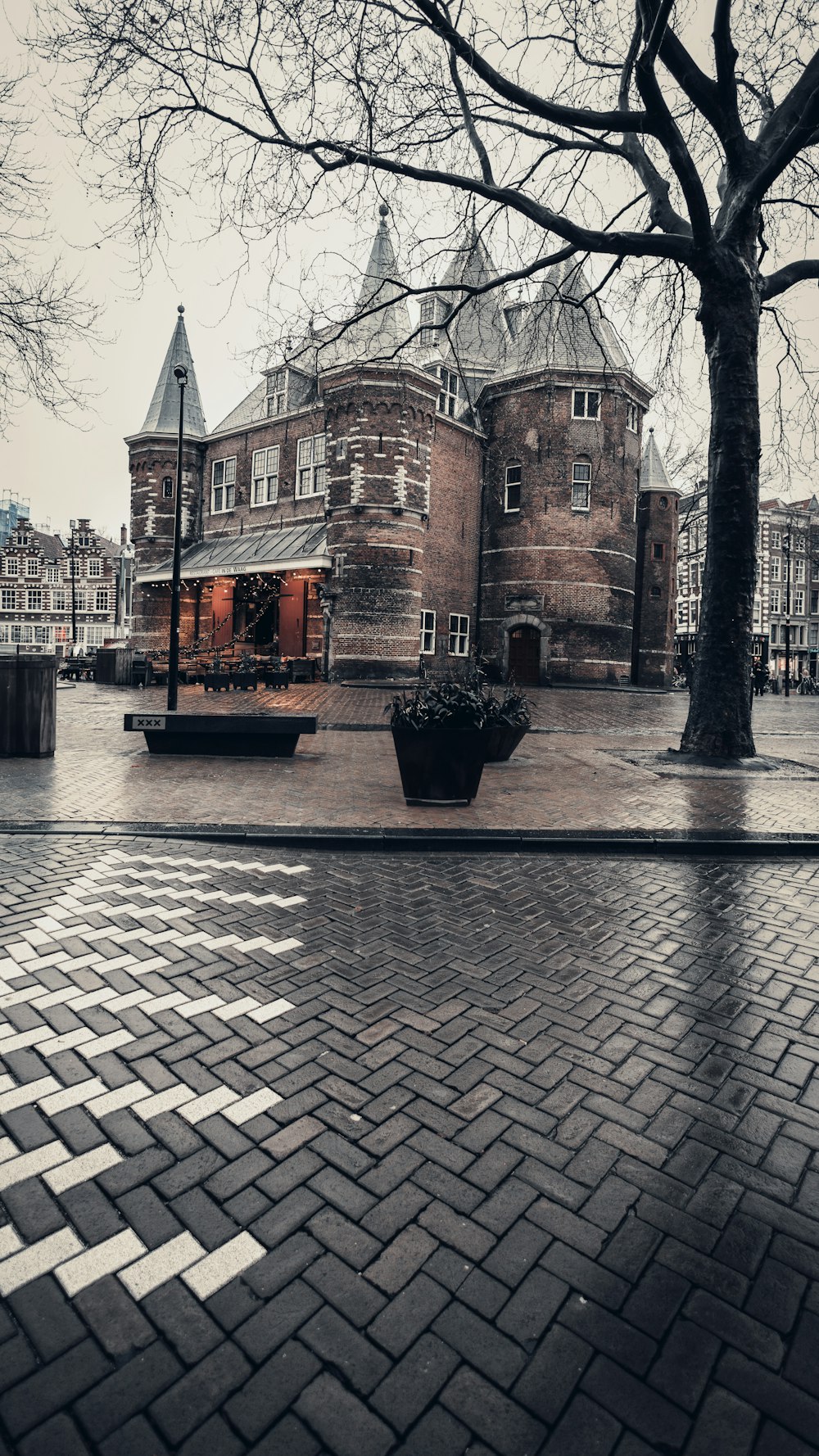 a large brick building with a tree in front of it