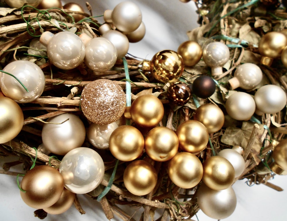 a bunch of gold and white ornaments sitting on top of a table