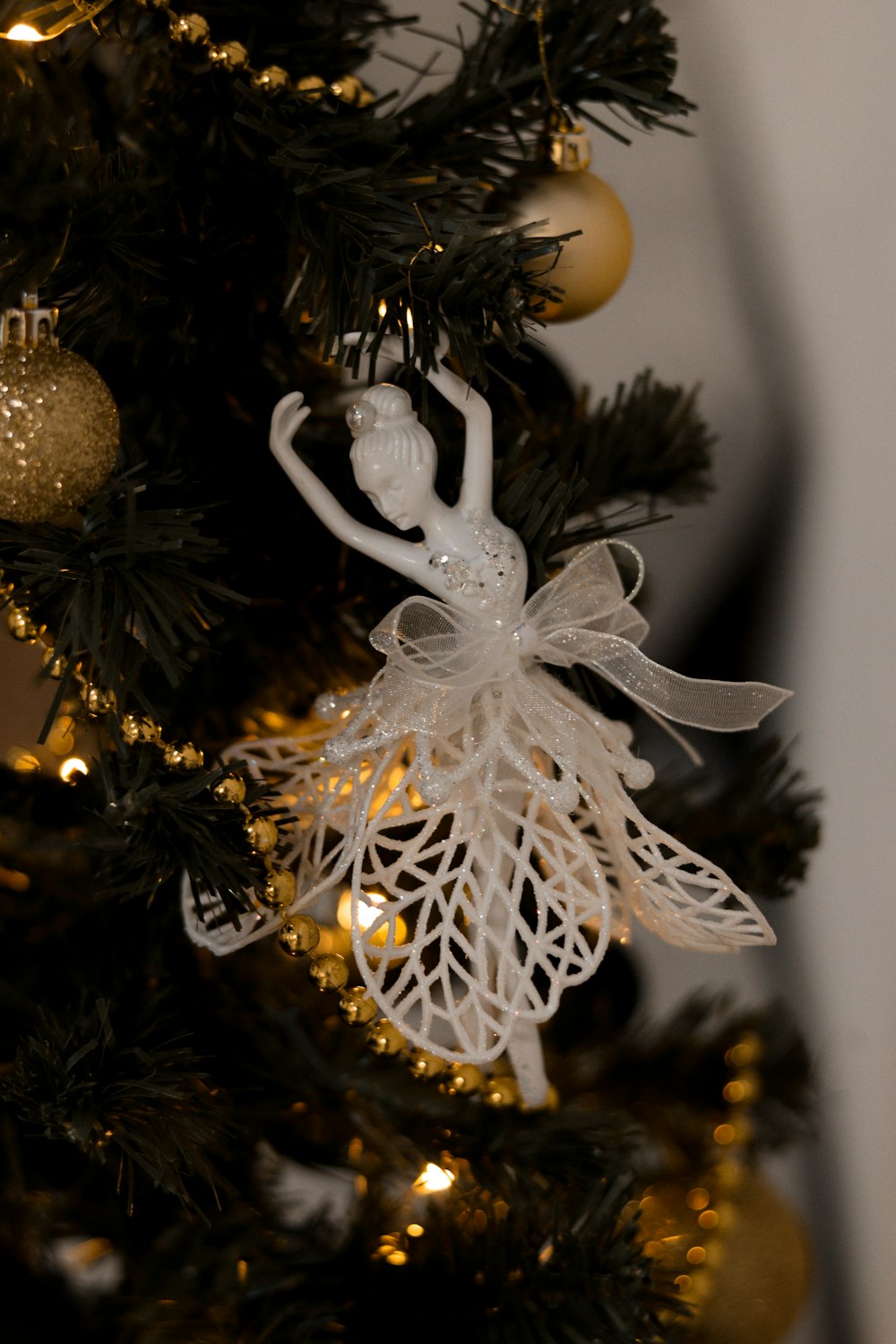 a christmas tree with a white angel ornament on it