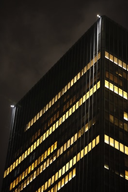 An evening view of the headquarters with lights glowing warmly through the windows.