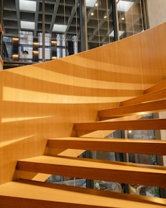 a close up of a wooden stair case in a building