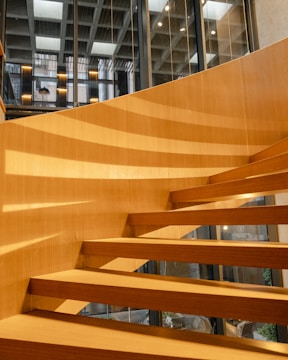 A spiral metal staircase bathed in natural light in a Bedford loft.
