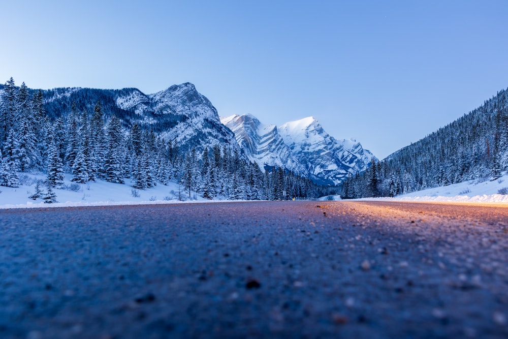 a road in the middle of a snowy mountain range