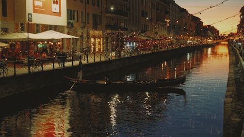 A lively gondola ride through the narrow canals of Venice at dusk.