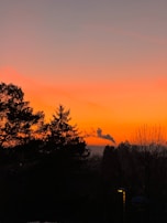 Sunset view over Köroğlu mountains with smoke rising from a cozy barbecue spot.