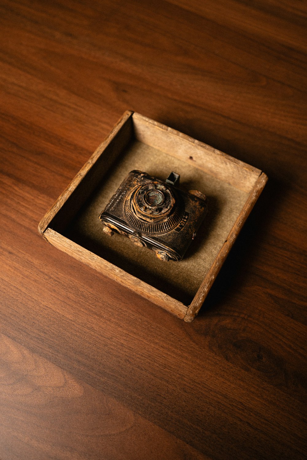 a wooden box with a camera inside of it