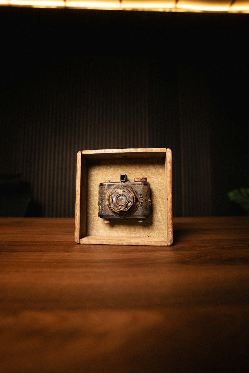 a wooden box with a camera inside of it