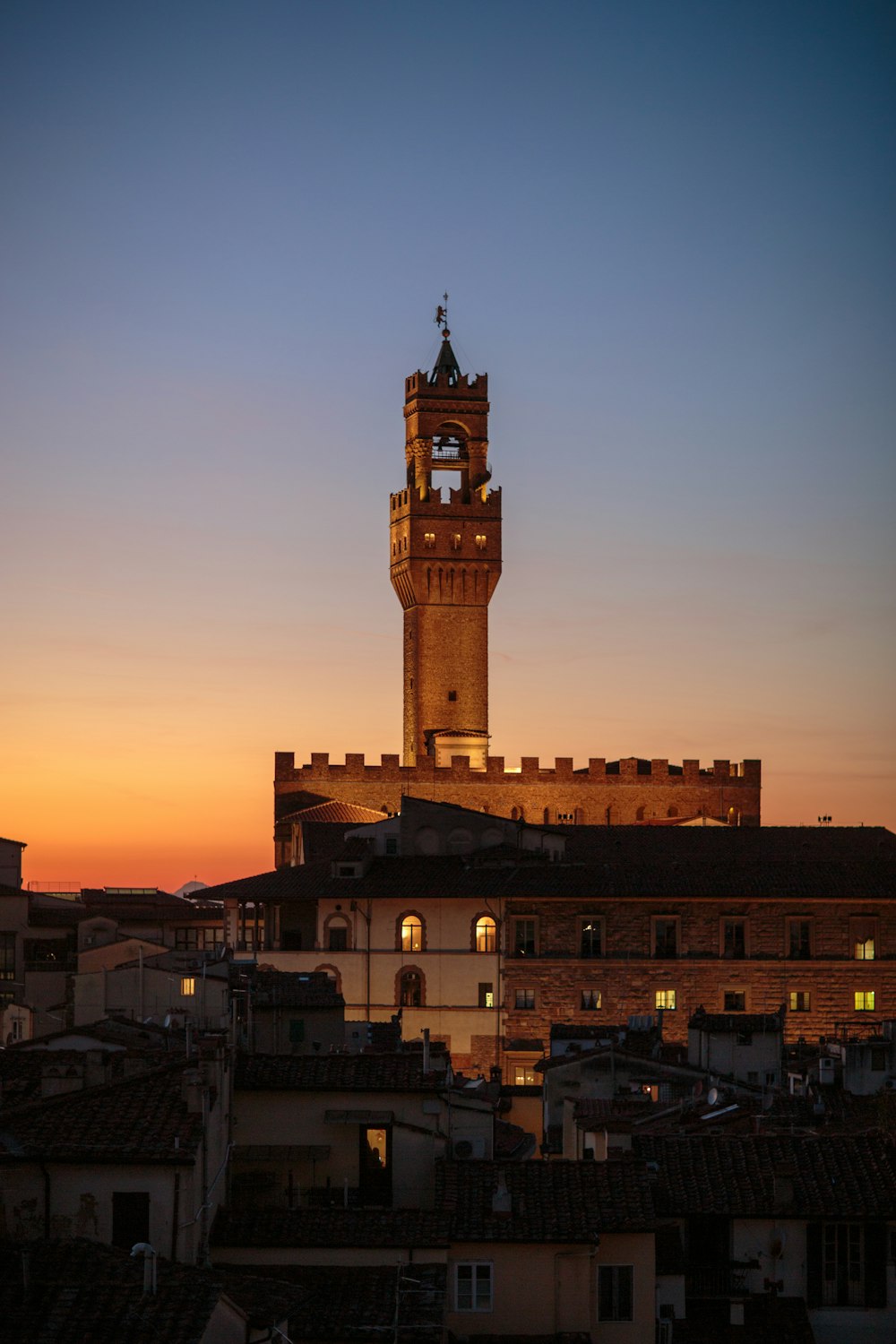 a tall clock tower towering over a city