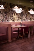 A cozy dining area adorned with tasteful wallpaper.