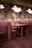 Cozy restaurant booth with elegant wooden details and warm lighting.