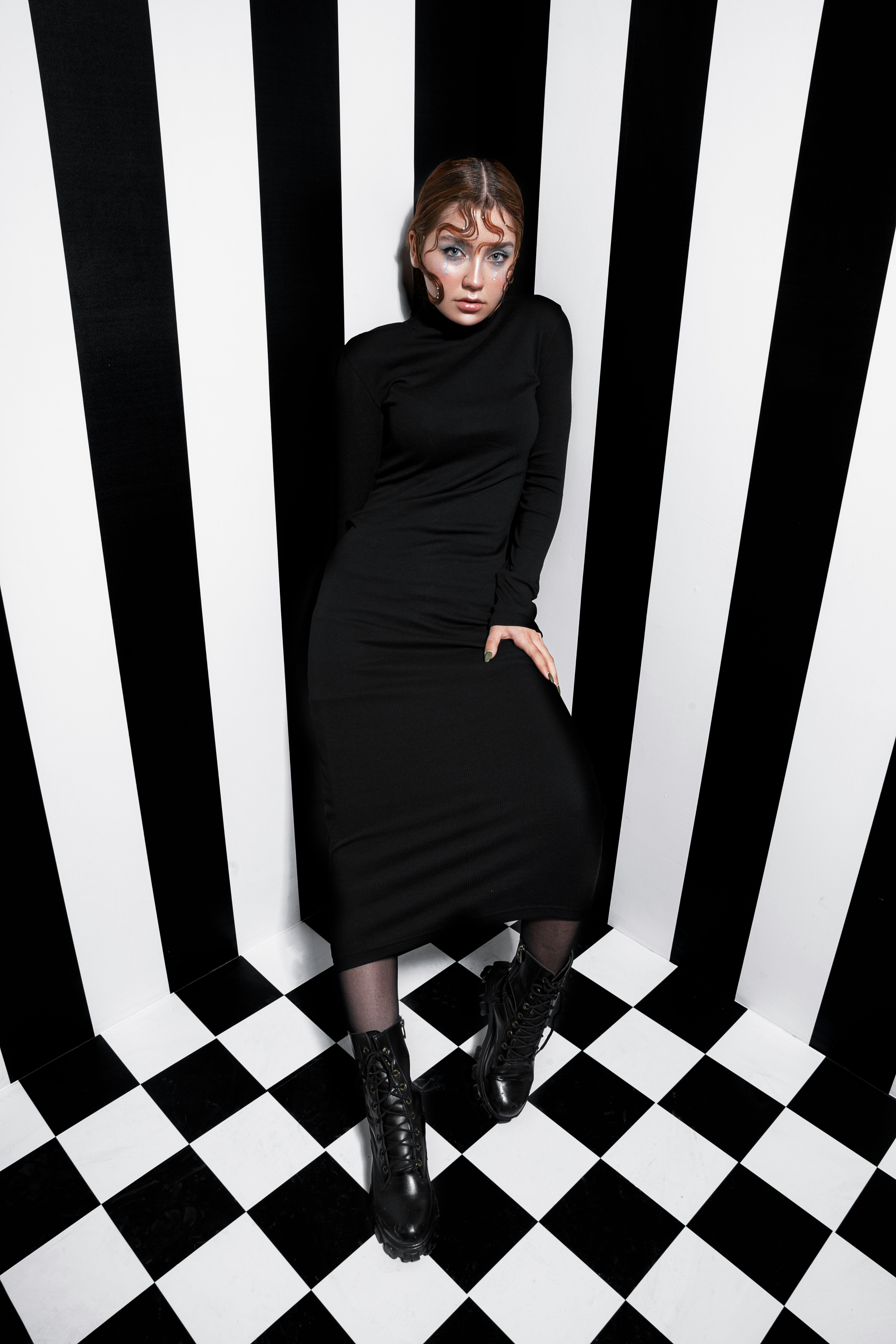 a woman in a black and white striped room