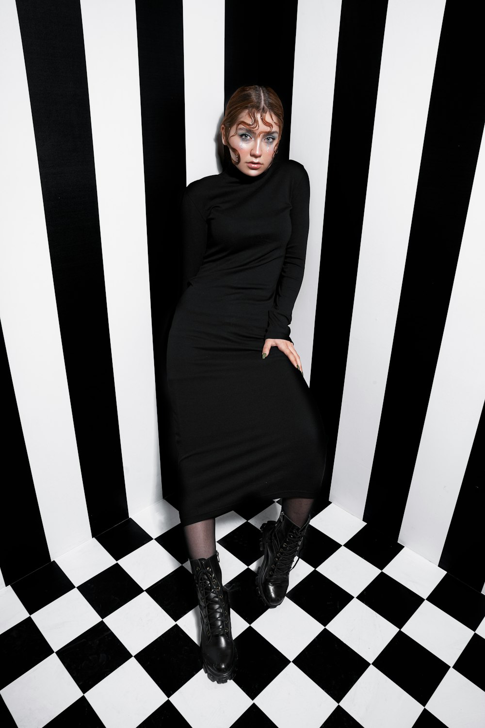 a woman in a black and white striped room
