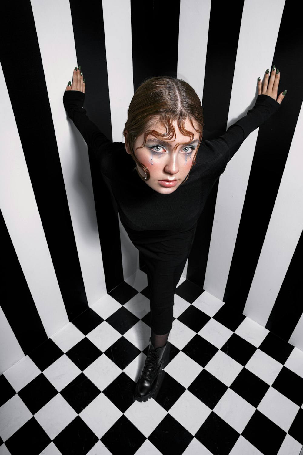 a woman in a black shirt and black and white checkered floor