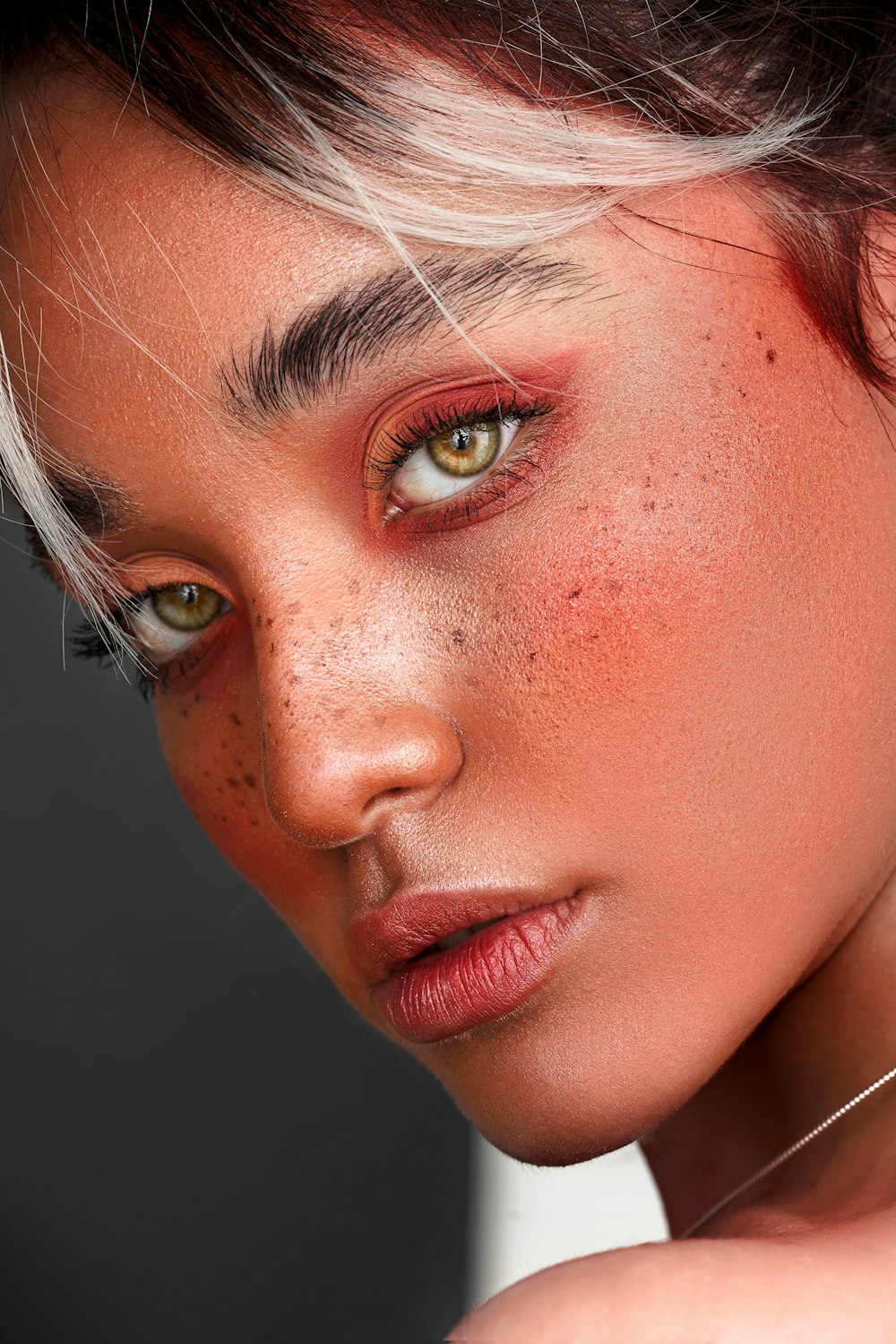 a close up of a woman with freckles on her face