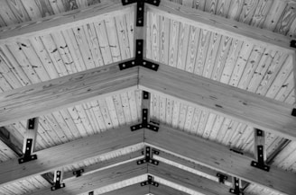 Structural alteration site with exposed beams and framework, illustrating thorough planning and skilled workmanship.