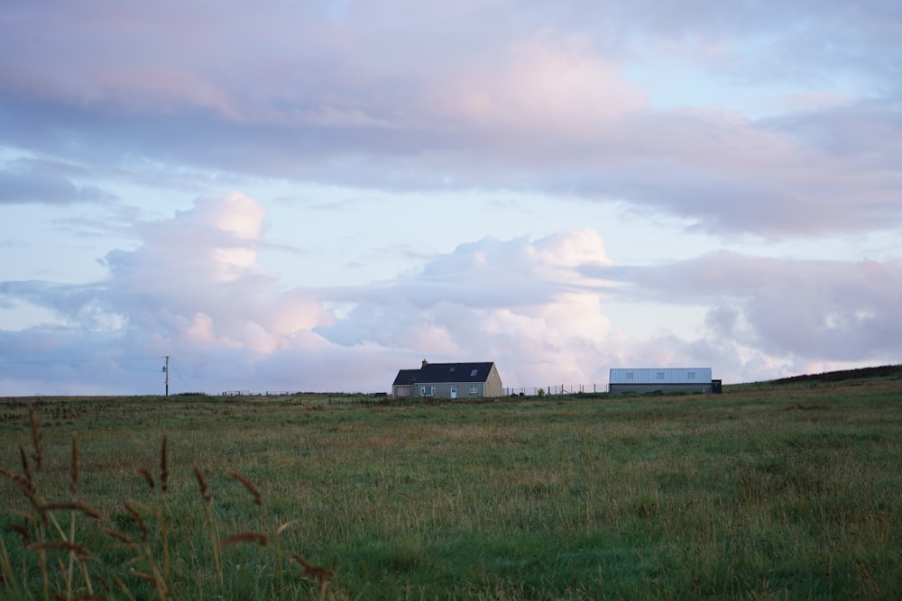 a house in the middle of a grassy field