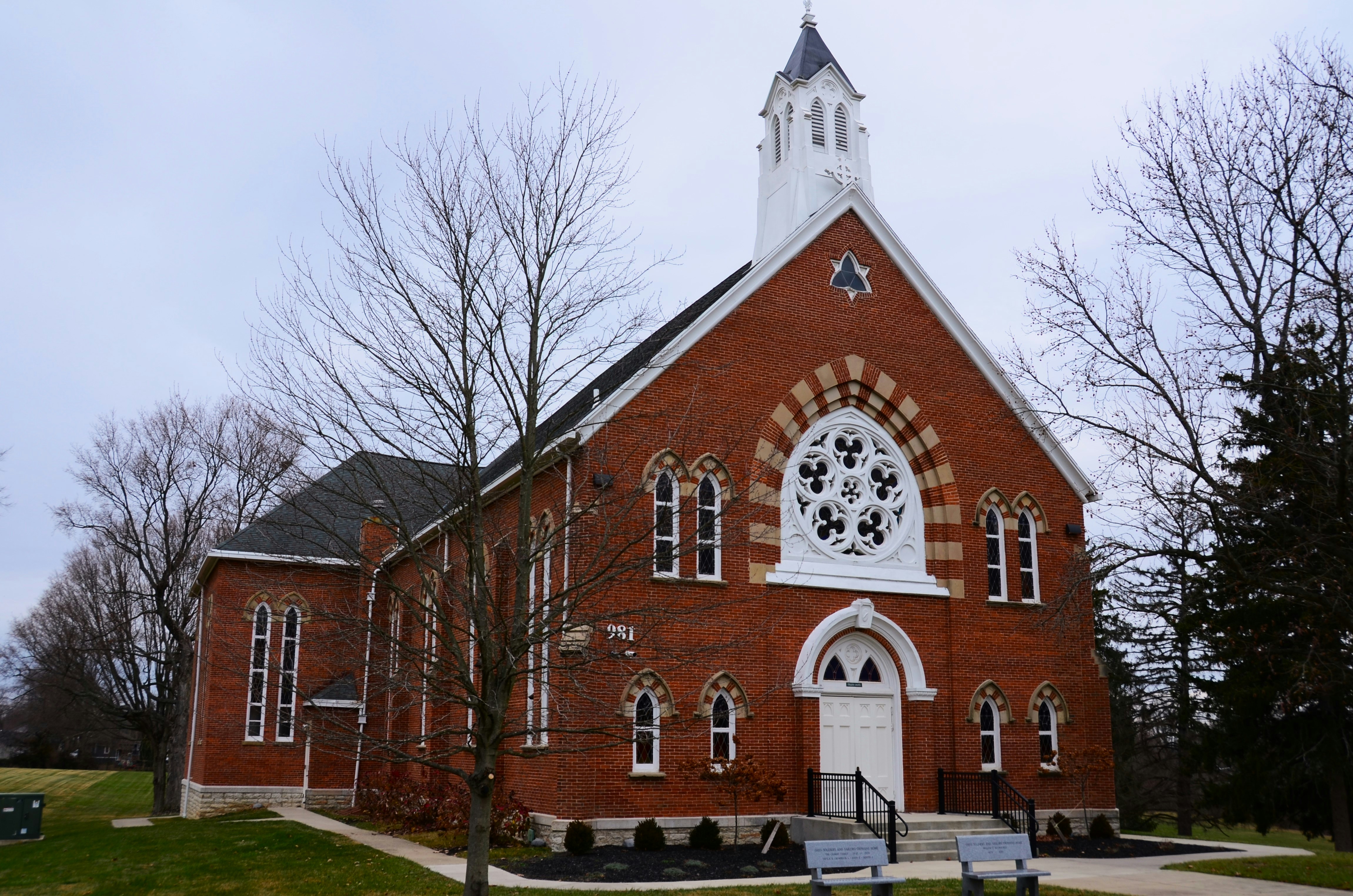 a red brick church with a white steeple