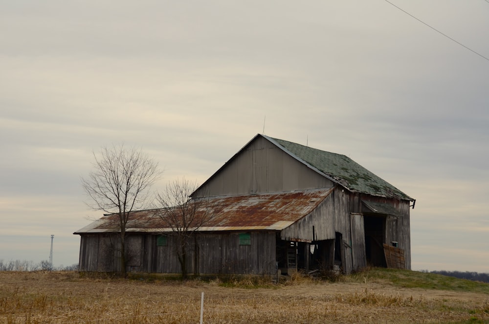 an old barn with a rusty tin roof