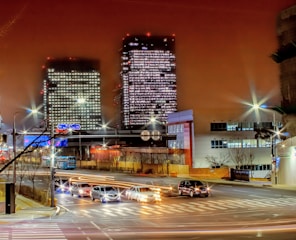 Night view of a cityscape with illuminated office buildings representing business growth.