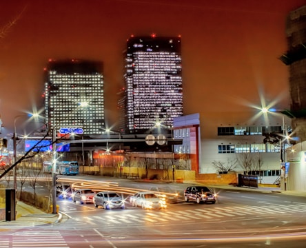 Night view of a cityscape with illuminated office buildings representing business growth.