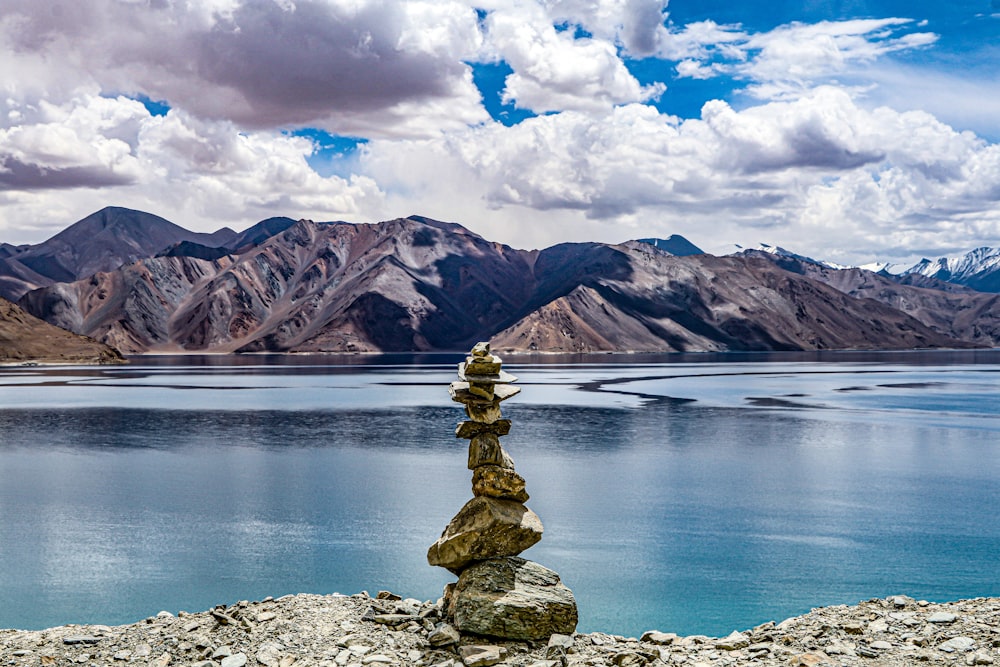 a stack of rocks sitting on top of a rocky hillside