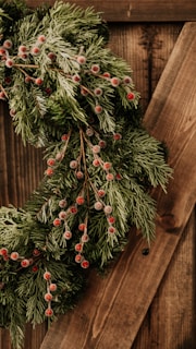 Handcrafted Christmas wreath made from natural, sustainable materials with vibrant red berries.